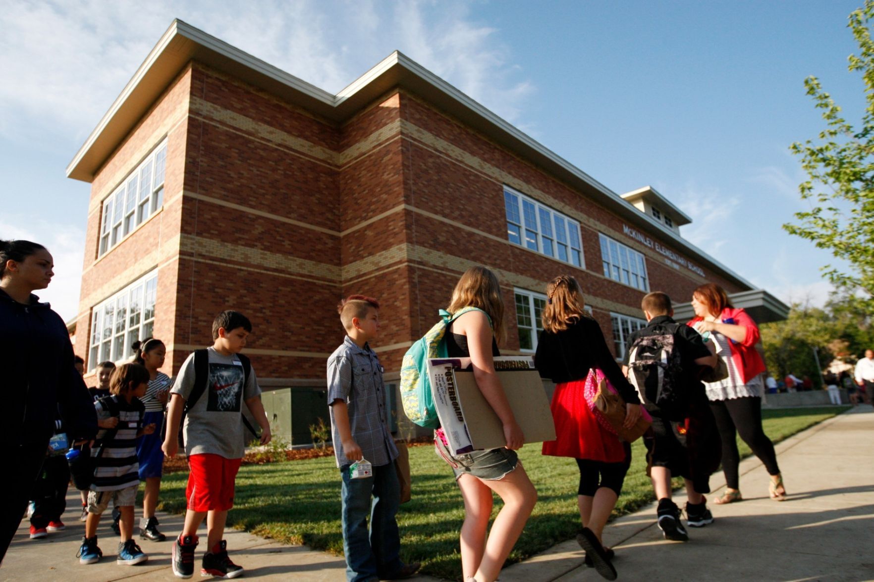 Teachers lead their classes around the building